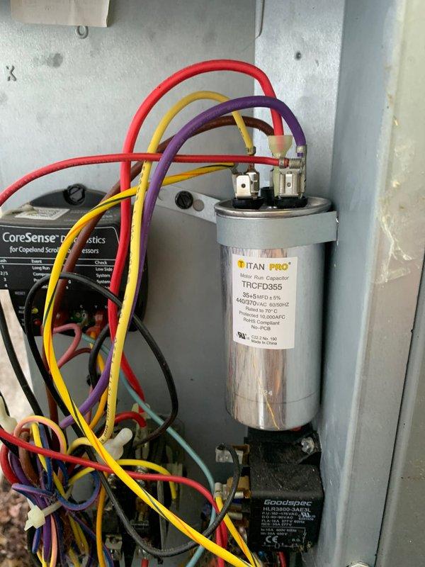Responded to no cooling complaint on ground-mounted unit U10. Found condenser fan motor not operating while compressor was running. Diagnosed failed dual run capacitor using digital manifold gauges and visual inspection of electrical components. Replaced TITAN PRO TRCFD355 capacitor rated at 440/370 VAC. Verified all electrical connections secure, tested system operation, and confirmed condenser fan motor and compressor both cycling properly with correct amperage draw. Unit cooling normally upon departure.