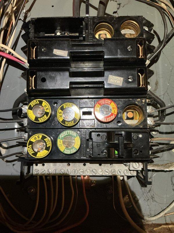 Responded to no power complaint where entire home lost power when air conditioning unit was turned off. Upon arrival, inspected main electrical service and fuse panel. Found outdated fuse block assembly with multiple Fusetron fuses showing signs of age and deterioration. Identified improper wiring connection causing AC system to be incorrectly tied to main power supply, resulting in complete power loss when AC was switched off. Corrected wiring configuration at fuse panel to isolate AC circuit from main service. Verified all fuses were properly rated and seated. Tested system by cycling AC unit on and off multiple times while confirming continuous power to remainder of home. All circuits restored to proper operation with AC now functioning independently of main power supply.