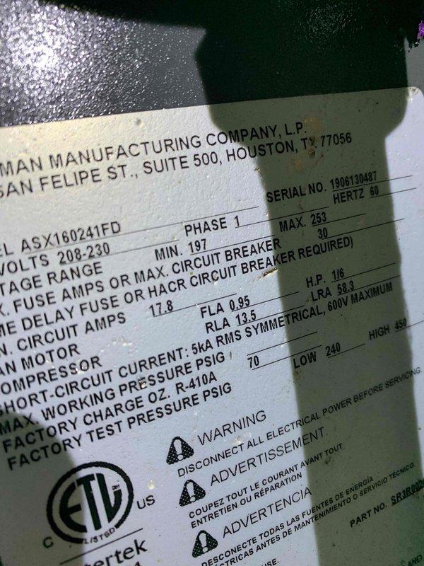Responded to no cooling call for residential air conditioning system. Upon arrival, performed diagnostic inspection of Goodman ASX160241FD condenser unit operating on R-410A refrigerant. Inspected electrical connections, wire routing through junction box, and verified proper insulation and sealing at penetration points. Documented equipment nameplate specifications including 208-230V single-phase configuration, 13.9 RLA compressor rating, and 1/6 HP motor. Captured photographic documentation of electrical junction connections with purple foam weatherproofing seal and unit identification label for service records. System evaluation completed and findings reviewed with customer.
