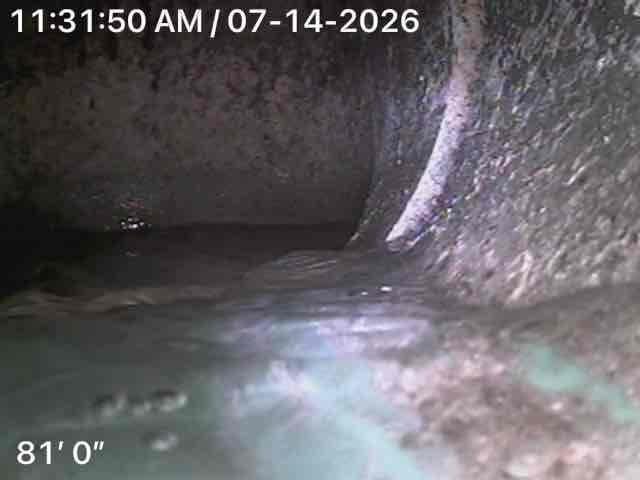 Performed video camera inspection of main sewer line to diagnose recurring backup issues. Camera was advanced 81 feet through the main line from interior access point in utility room. Inspection revealed significant debris accumulation and buildup within the line at the 81-foot mark, consistent with reported backup symptoms. Documented findings with timestamped video footage showing interior pipe conditions, joint connections, and areas of concern that would require further clearing or repair to restore proper drainage flow.