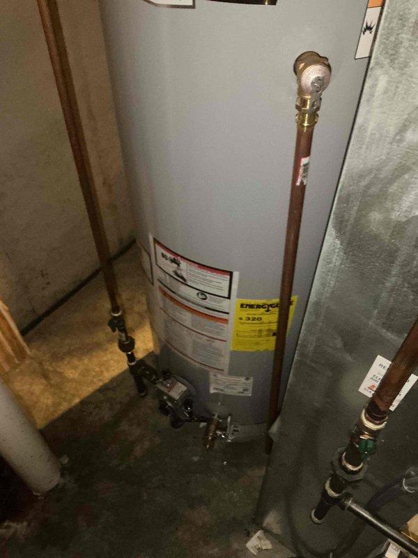 Completed installation of 50-gallon tall gas-fired water heater in residential utility space. Connected copper supply lines with proper shutoff valves, installed gas piping with code-compliant black iron pipe and shut-off valve, and attached pressure relief valve with discharge piping. All plumbing connections were secured and tested for proper operation and leak-free performance.