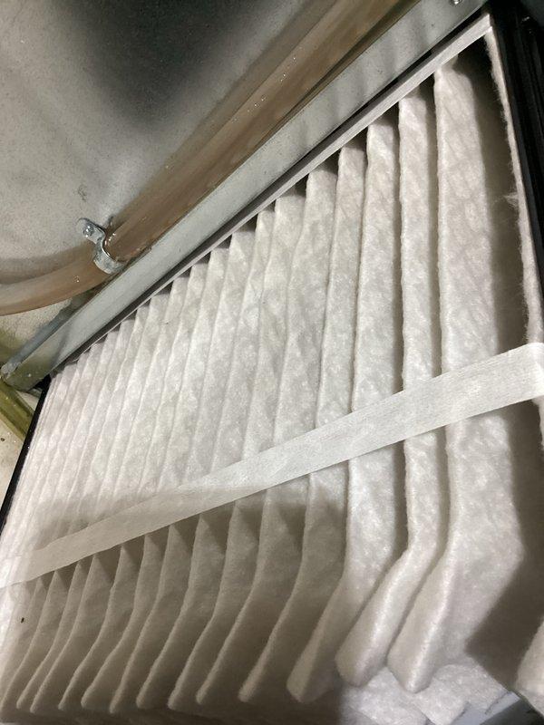 # HVAC Cooling System Tune-Up Completed

Performed comprehensive seasonal cooling maintenance on a 7-year-old outdoor condenser unit and associated air handling system. Inspected and evaluated air filter condition within the indoor air handler, confirming proper installation and adequate filtration performance. Conducted thorough examination of outdoor condenser unit including coil surfaces, which showed moderate accumulation of environmental debris on protective mesh panels. Assessed condenser pad condition and noted typical weathering consistent with outdoor installation. Verified all mechanical components, electrical connections, and refrigerant system parameters were within manufacturer specifications. Unit tested and confirmed operational for cooling season.