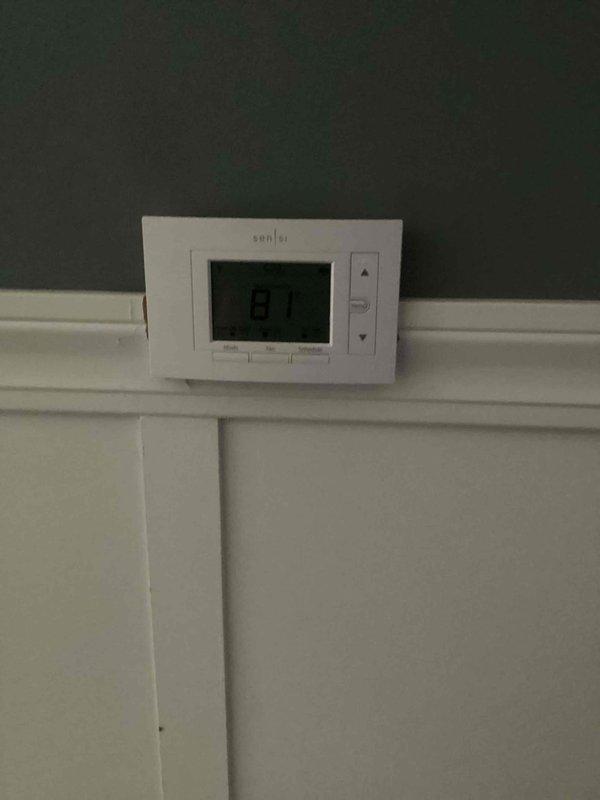 Responded to service call for A/C unit emitting burning rubber odor in basement. Performed diagnostic inspection of 10-year-old system, examining electrical components, wiring connections, and control board for signs of overheating or damaged insulation. Verified thermostat operation and system functionality, documented equipment condition with photos showing interior wiring assembly and control components.