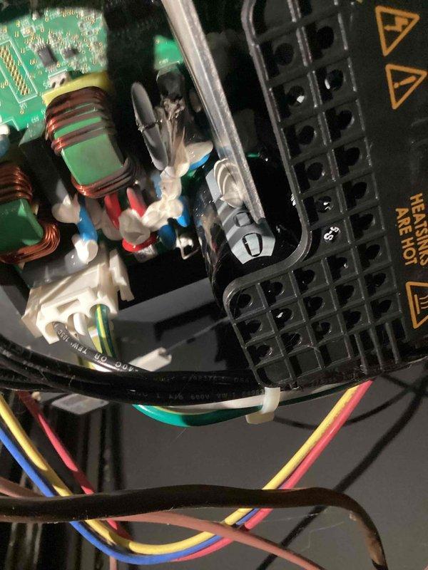Responded to service call for A/C unit emitting burning rubber odor in basement. Performed diagnostic inspection of 10-year-old system, examining electrical components, wiring connections, and control board for signs of overheating or damaged insulation. Verified thermostat operation and system functionality, documented equipment condition with photos showing interior wiring assembly and control components.
