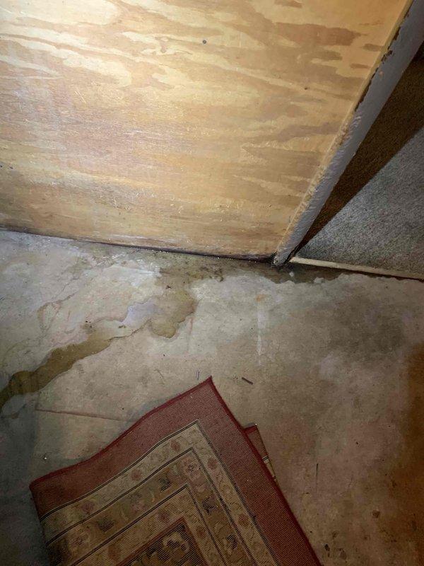 Responded to callback for air conditioning unit not cooling following previous service appointment. Upon arrival, discovered water heater leakage in basement causing excessive humidity levels affecting HVAC system performance. Documented extensive water damage on concrete floor around dual water heater installation with visible staining and moisture accumulation. Advised customer that plumbing issue must be resolved and basement humidity controlled before air conditioning system can operate effectively.