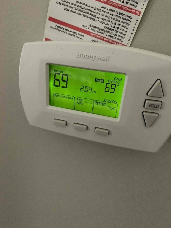 Responded to report of inadequate cooling in bedroom system. Upon inspection, found extensive rust and corrosion on critical mounting bracket components within the air handler compartment, indicating prolonged moisture exposure that could compromise system integrity and performance. Verified thermostat operation showing system calling for cooling at 69°F setpoint. Documented conditions with photos and contacted customer with diagnosis of corroded internal components requiring attention to restore proper cooling efficiency and prevent potential system failure.
