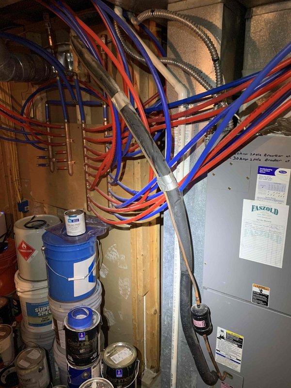 Responded to service call for water leakage from basement A/C unit. Upon inspection, discovered active condensate drainage issue causing significant water accumulation on concrete floor with visible staining and moisture damage along baseboards and wall corners. Inspected 10-year-old air handler and associated mechanical systems in basement utility area. Identified compromised condensate drain line requiring attention to prevent further water intrusion and potential mold growth.