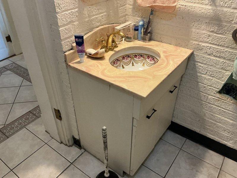 Responded to service call for reported toilet backing up in bathroom. Upon arrival, performed visual inspection of toilet and surrounding plumbing fixtures. Toilet was equipped with accessibility grab bars and appeared to be in clean condition with clear water in bowl. 

Assessed bathroom plumbing system including visible PVC drainage pipes and supply lines. Checked bathroom vanity sink with decorative porcelain basin and brass fixtures for any related drainage issues. Inspected floor-mounted shut-off valves and supply lines beneath vanity cabinet.

Tested toilet function and drainage flow. Plunger was available on-site for clearing potential blockages. Evaluated drainage system performance and identified source of backup issue. Performed necessary clearing procedures to restore proper toilet function and drainage. Verified all fixtures were operating correctly upon completion. Documented conditions with photographs for service records.