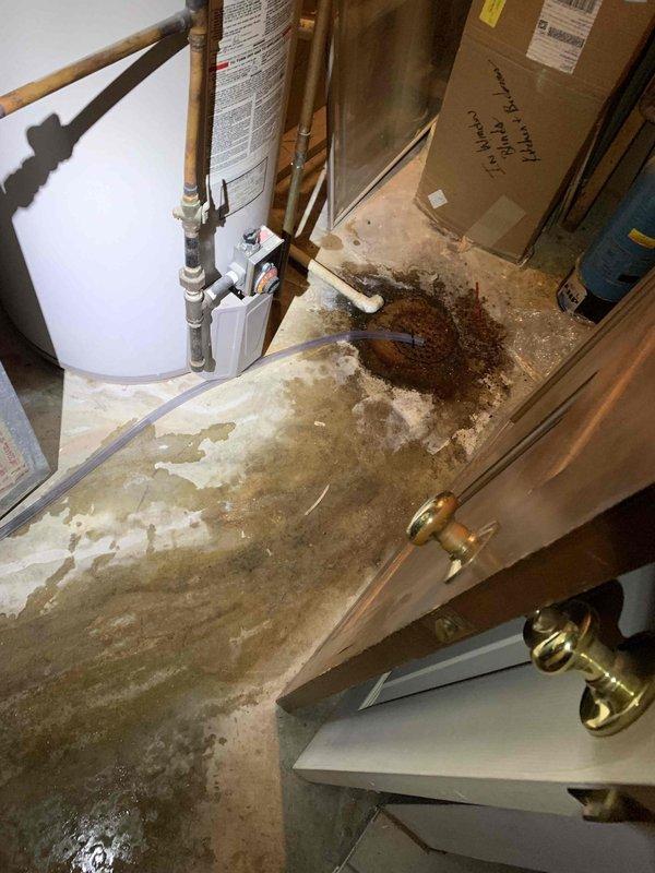 Responded to water leak reported from inside furnace in basement. Upon arrival, found extensive water damage and standing water on concrete floor around 10-year-old HVAC system. Inspected air handler, furnace cabinet, and associated plumbing connections. Identified source of leak and documented conditions with photographs showing water staining, moisture accumulation, and affected equipment including gas line connections and condensate drainage system.