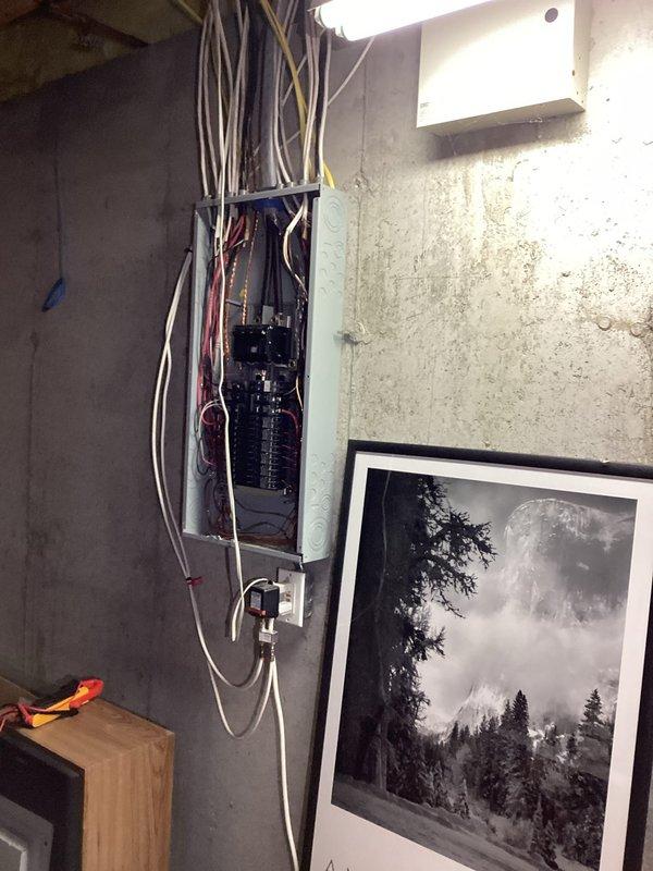 Responded to report of kitchen lights flickering when air conditioning unit activates. Inspected main electrical panel and identified loose neutral connections causing voltage fluctuations during high-load startup conditions. Tightened all neutral bus bar connections, verified proper torque specifications on main breaker terminals, and confirmed all branch circuit connections were secure. Tested system operation through multiple A/C cycling events to verify flickering issue was resolved and electrical system remained stable under load.