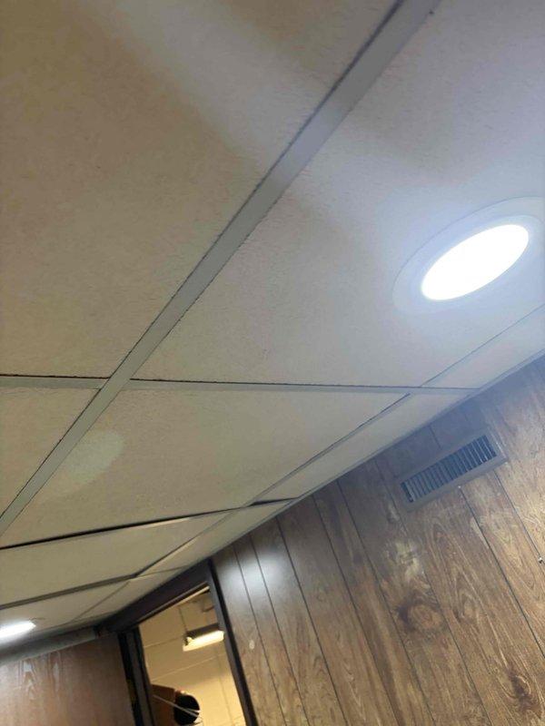 Coordinated with HVAC contractor on initial site visit to assess and plan completion of range hood installation project. Documented existing ceiling configuration with drop ceiling tiles, recessed lighting, and wall finishes to determine final electrical connection requirements for kitchen exhaust system.