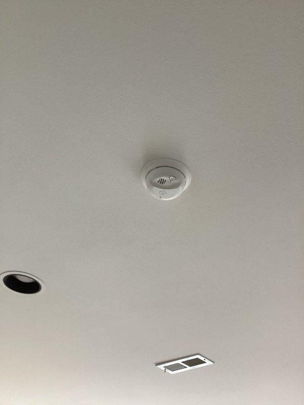 Completed installation of smoke detectors in residential property. Mounted two circular smoke alarm units to ceiling surfaces, ensuring proper placement and secure attachment in accordance with local fire safety codes. All devices tested and confirmed operational upon completion.