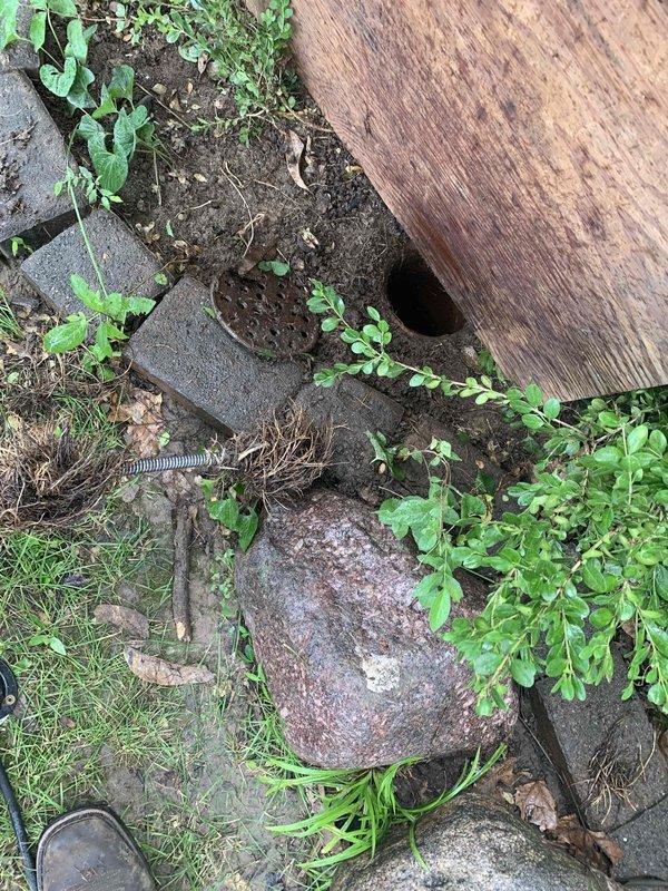 Responded to a clogged drain call at a 70-year-old residential property. Upon inspection, located heavily corroded cast iron drain stack in basement with significant rust deterioration throughout the vertical piping system. Accessed cleanout port on main drain line and cleared obstruction using mechanical augering equipment. Inspected exterior drain access point beneath deck structure, removing accumulated debris and vegetation that had infiltrated the system. Successfully restored proper drainage flow and confirmed clearance with water test.