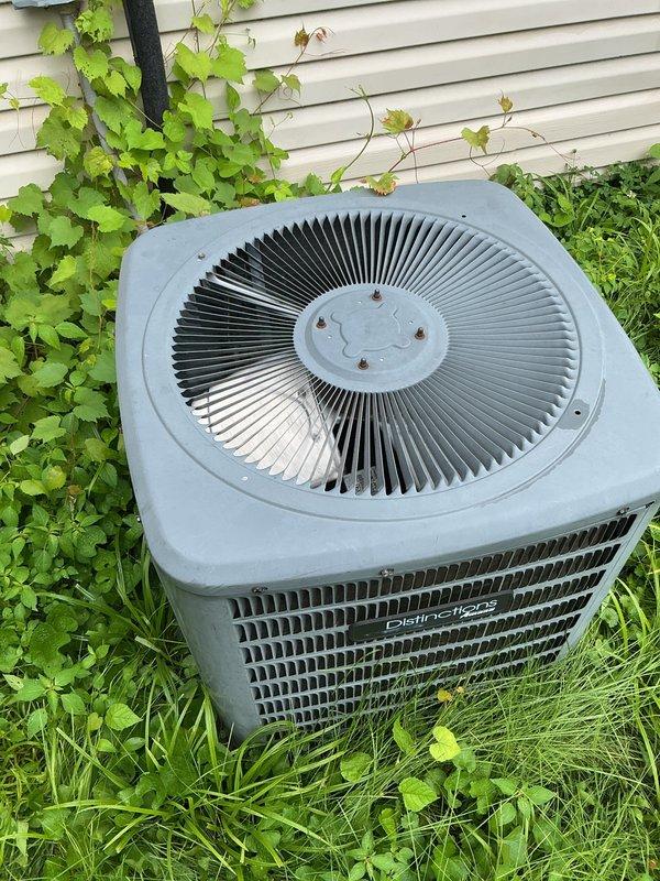 Responded to water leak complaint on 15-year-old residential split AC system. Upon arrival, inspected indoor air handler unit located in utility closet and outdoor Distinction brand condenser unit. Identified source of water leak at indoor unit. Cleared condensate drain line obstruction and verified proper drainage flow. Inspected evaporator coil drain pan for cracks or damage, confirmed integrity. Checked refrigerant lines and insulation for condensation issues. Tested system operation and confirmed no further leaking. Documented equipment condition with photographs of both indoor and outdoor units for service records.