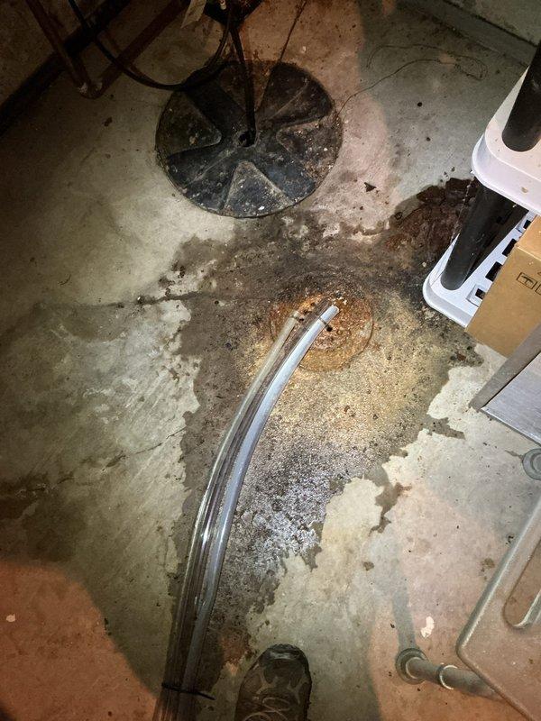 Responded to callback for water pooling on basement floor from air conditioning unit. Upon arrival, discovered condensate drain hose had been cut too short during previous maintenance visit and was not reaching floor drain, causing water to discharge directly onto concrete floor. Replaced inadequate drain line with properly sized hose, ensuring secure connection from evaporator coil drain pan to floor drain. Verified proper drainage flow and confirmed no water leakage onto floor. Unit tested and operating normally with condensate now draining appropriately into floor drain system.