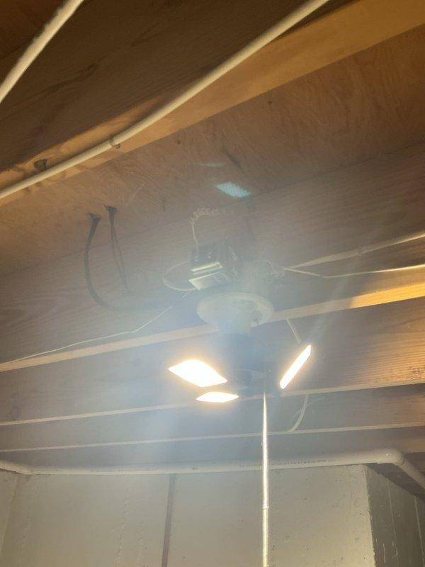 Completed electrical panel evaluation and ceiling fan fixture inspection at property with aluminum wiring. Assessed 200-amp main breaker panel with dual-column circuit breaker configuration serving multiple circuits including range, solar system, HVAC, kitchen, and garage smoke detectors. Verified proper labeling and operational status of all breakers, documented panel configuration, and inspected ceiling-mounted fan/light combination fixture in basement area to ensure safe operation with existing aluminum wiring system.