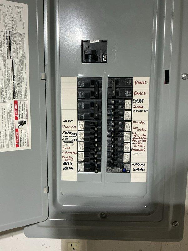 Completed electrical panel evaluation and ceiling fan fixture inspection at property with aluminum wiring. Assessed 200-amp main breaker panel with dual-column circuit breaker configuration serving multiple circuits including range, solar system, HVAC, kitchen, and garage smoke detectors. Verified proper labeling and operational status of all breakers, documented panel configuration, and inspected ceiling-mounted fan/light combination fixture in basement area to ensure safe operation with existing aluminum wiring system.
