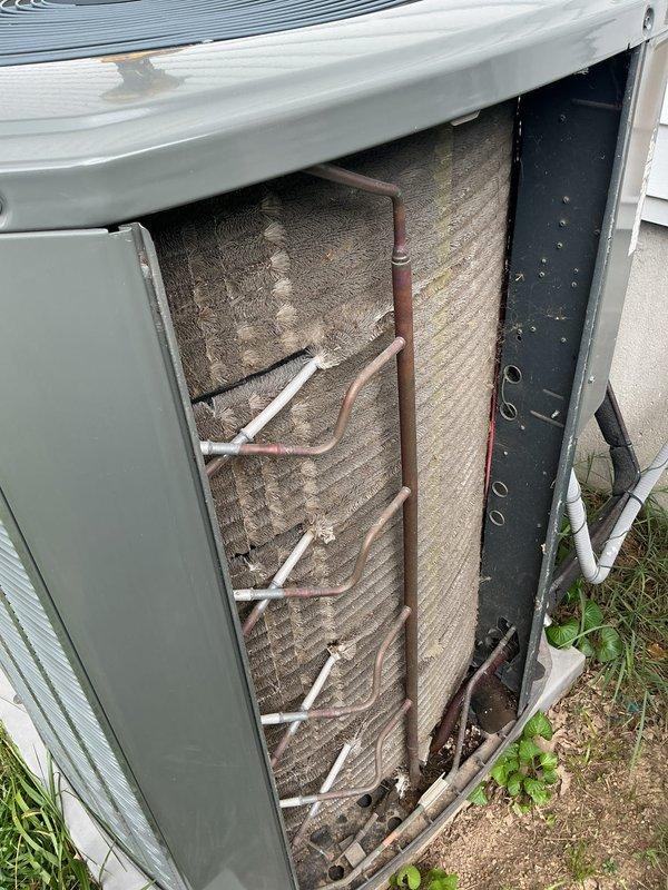 Completed preventive maintenance tune-up on 2016 outdoor air conditioning unit. Performed comprehensive system inspection, removed access panel to evaluate internal components, and documented heavily soiled evaporator coil with significant dirt and debris accumulation restricting airflow between fins. Inspected refrigerant lines, copper tubing connections, and heat exchanger assembly for proper operation and visible defects.