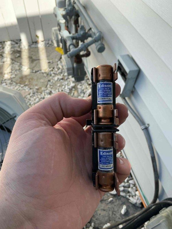 Responded to no-cool call on 10+ year old system with outdoor condenser not operating. Upon inspection, found both fuses in the disconnect blown, indicating electrical fault or component failure. Replaced failed fuses, tested system operation, and verified compressor and condenser fan motor now functioning properly with normal amperage draw.