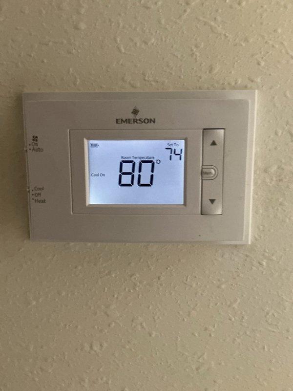 Responded to no cooling complaint on residential air conditioning system. Upon arrival, found thermostat calling for cooling with system running but unable to reach setpoint of 74°F, with room temperature at 80°F. Inspected indoor air handler and discovered heavily loaded 16x25x1 air filter restricting airflow. Replaced dirty filter with new filter to restore proper system airflow and cooling capacity. Verified system operation and cooling cycle functionality before departure.