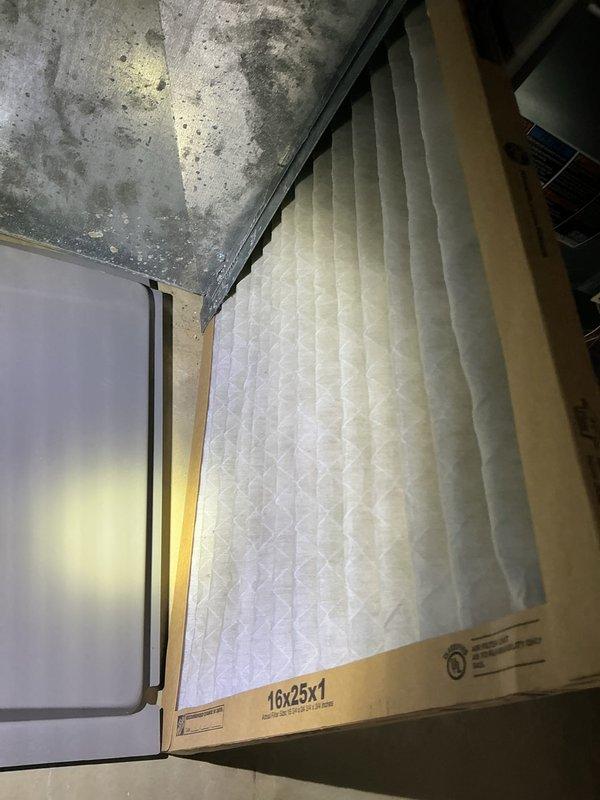 Responded to no cooling complaint on residential air conditioning system. Upon arrival, found thermostat calling for cooling with system running but unable to reach setpoint of 74°F, with room temperature at 80°F. Inspected indoor air handler and discovered heavily loaded 16x25x1 air filter restricting airflow. Replaced dirty filter with new filter to restore proper system airflow and cooling capacity. Verified system operation and cooling cycle functionality before departure.