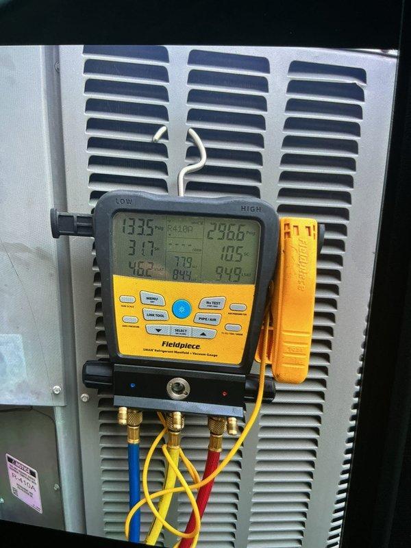 Responded to no cooling complaint on 10+ year old residential air conditioning unit located on side of home. Customer reported thermostat set at 72°F but displaying 75°F, with unusual noise coming from basement equipment. Upon arrival, performed comprehensive system diagnostics using digital manifold gauges to measure refrigerant pressures and temperatures across the system. Connected Fieldpiece manifold to service ports and monitored high-side and low-side pressures while system was operating. Evaluated superheat and subcooling values to determine refrigerant charge status and system performance. Inspected condenser unit and basement air handler for source of reported noise. Measurements indicated system performance issues requiring further evaluation. Documented system readings and equipment conditions with photographic evidence for customer records.