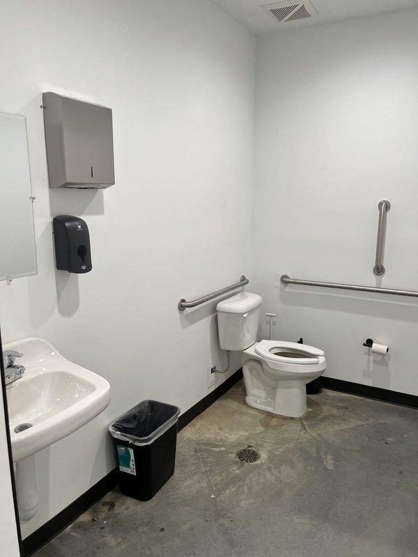 Responded to a clogged toilet in an ADA-compliant commercial restroom within an office building. Upon arrival, assessed the accessible bathroom featuring wall-mounted fixtures, grab bars, and floor drain. Successfully cleared the toilet obstruction using professional drain cleaning equipment after initial customer attempts were unsuccessful, restoring full functionality to the fixture.