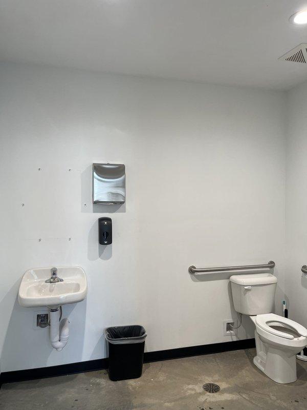 Responded to a clogged toilet in an ADA-compliant commercial restroom within an office building. Upon arrival, assessed the accessible bathroom featuring wall-mounted fixtures, grab bars, and floor drain. Successfully cleared the toilet obstruction using professional drain cleaning equipment after initial customer attempts were unsuccessful, restoring full functionality to the fixture.