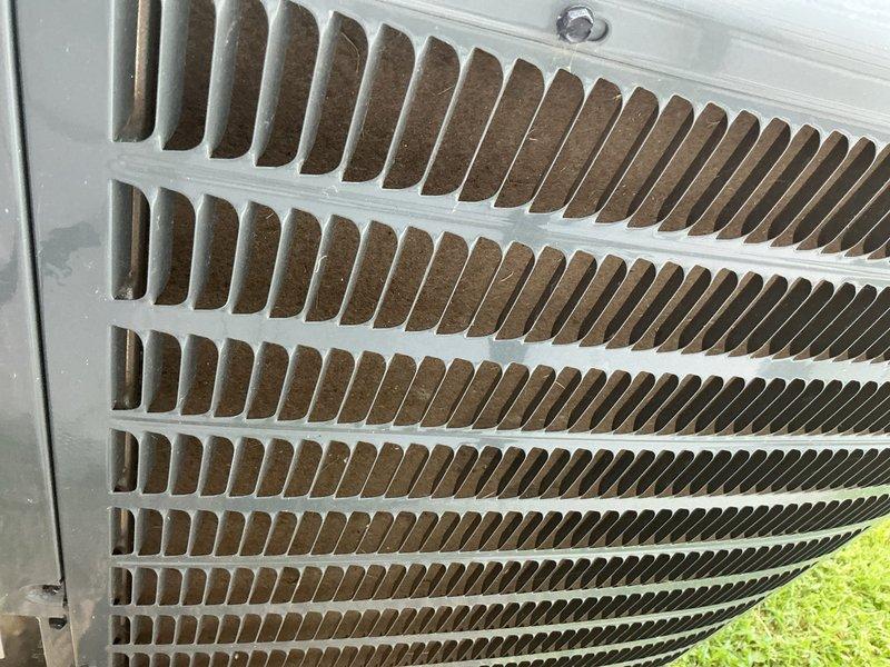 Responded to no-cool complaint with evaporator coil freeze-up on two-year-old residential air conditioning system affecting entire home. Upon inspection, found outdoor condenser coil heavily contaminated with dirt and debris accumulation restricting airflow, contributing to improper system operation and refrigerant pressure imbalance. Performed visual inspection of control board and low-voltage wiring connections, verified all terminations secure at terminal block. Documented condenser coil condition and control board configuration with photos for warranty consideration given unit age. Advised customer of findings and recommended thorough coil cleaning, refrigerant charge verification, and airflow diagnostics to resolve freezing condition and restore proper cooling operation.