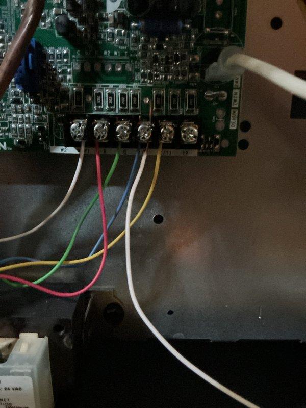 Responded to no-cool complaint with evaporator coil freeze-up on two-year-old residential air conditioning system affecting entire home. Upon inspection, found outdoor condenser coil heavily contaminated with dirt and debris accumulation restricting airflow, contributing to improper system operation and refrigerant pressure imbalance. Performed visual inspection of control board and low-voltage wiring connections, verified all terminations secure at terminal block. Documented condenser coil condition and control board configuration with photos for warranty consideration given unit age. Advised customer of findings and recommended thorough coil cleaning, refrigerant charge verification, and airflow diagnostics to resolve freezing condition and restore proper cooling operation.