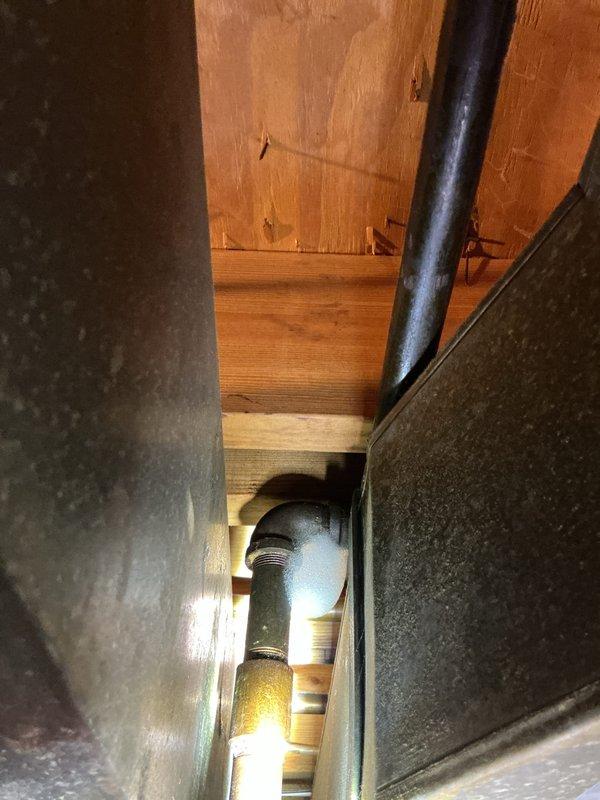 Responded to emergency service call at 60-year-old residence where carbon monoxide detector alarm led to discovery of main gas line leak. Utility company confirmed leak and shut off gas supply to entire home pending repairs. Performed gas line repair work to restore safe operation of gas service. Installed 50-gallon tall electric water heater as replacement unit. Completed all necessary gas line work to address leak in aged copper piping system. Obtained plumbing permit #26plu-14402 for installation and applied required plumbing identification sticker per regulatory requirements. Repaired compromised gas piping showing corrosion and oxidation consistent with building age. Tested all gas connections for leaks upon completion of repairs. Restored gas service to home and verified proper operation of all gas appliances. New water heater installation completed with all connections properly secured and system tested for functionality.