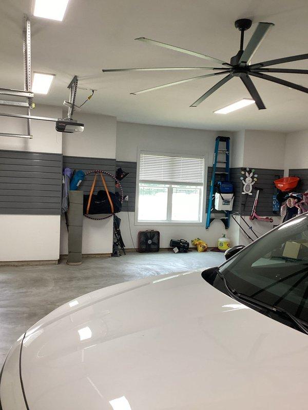 Responded to service call for garage ceiling fan with no airflow. Inspected large industrial-style ceiling fan and verified motor operation. Determined fan was functioning properly but rotating in reverse direction, pulling air upward instead of circulating downward. Reversed fan direction using directional switch to correct airflow pattern and confirmed proper air circulation throughout garage space. Provided quote for installation of two exterior GFCI-protected outlets per customer request.