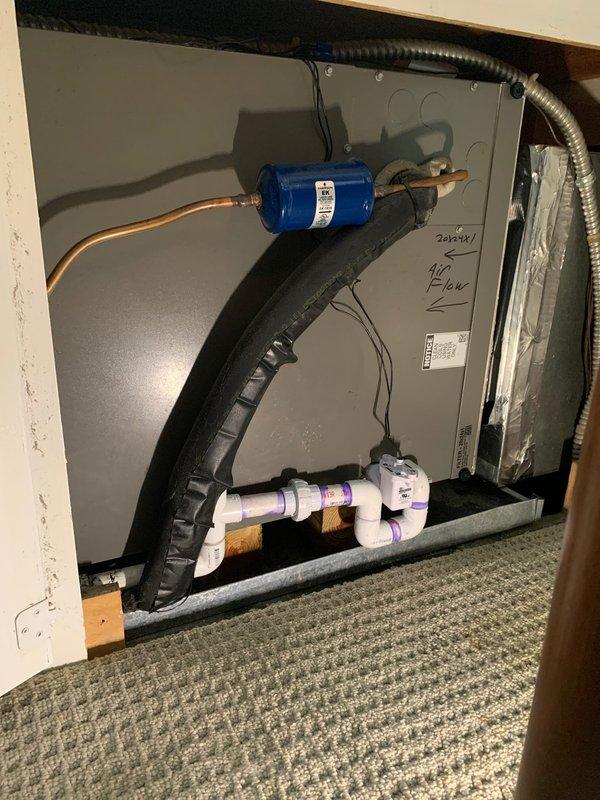 Returned to complete installation by redoing condensate drain PVC piping with proper fittings and connections, and installed SafeT switch on air handler unit. Removed and replaced previous drain line assembly with corrected configuration to ensure proper condensate removal and system protection.