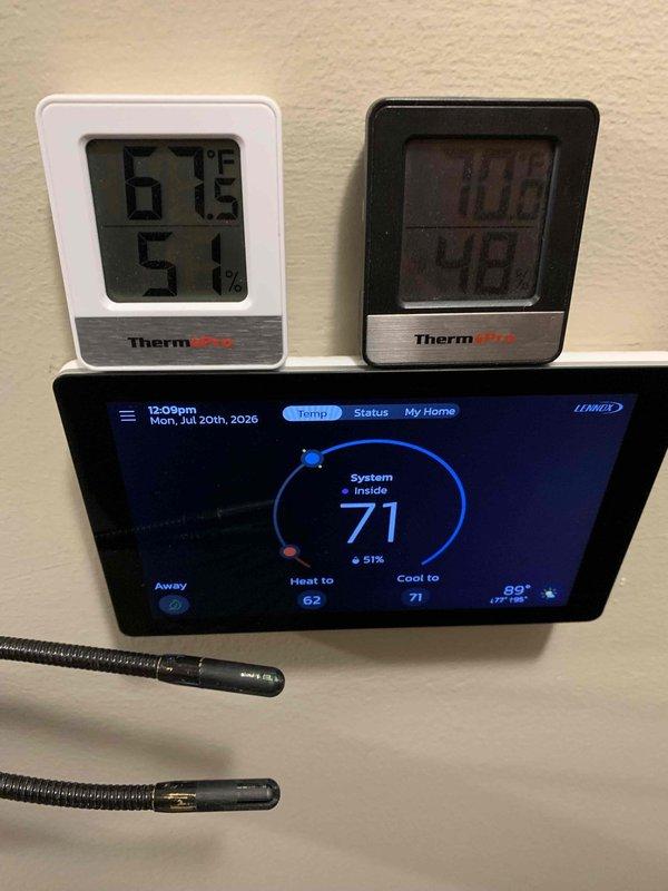 Responded to service call for humidity concerns following recent new installation. Upon arrival, verified system operation and conducted comprehensive humidity monitoring using multiple calibrated measurement devices. Installed and configured digital hygrometers at strategic locations to establish baseline humidity readings throughout conditioned space. Verified Carrier thermostat programming and humidity control settings, confirming system displayed 71°F with 51% relative humidity. Cross-referenced thermostat readings against independent ThermoPro monitoring devices showing consistent measurements in the 69-71°F range with 50-57% humidity levels. Adjusted thermostat heat setpoint to 62°F and cooling setpoint to 71°F per comfort requirements. Confirmed proper system response and dehumidification operation. All monitoring equipment reading within acceptable parameters for indoor comfort standards.