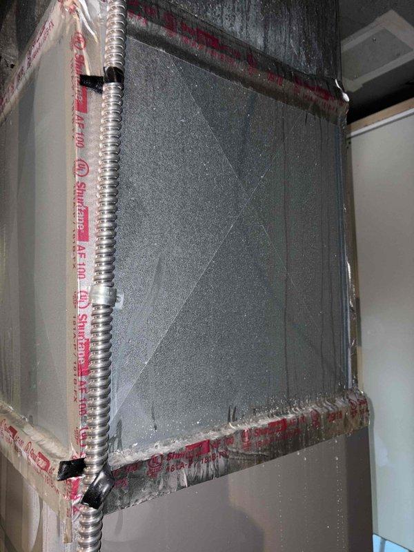 Performed comprehensive diagnostic evaluation on dual-zone HVAC system addressing weak airflow and temperature differential in 450 sq ft family/great room served by 4.5-ton unit. Conducted static pressure testing, measured actual CFM at supply registers, and evaluated return air configuration on both the 4-year-old main level system and 10-year-old upper floor unit. Inspection revealed outdoor condenser filter media with significant dust loading and uneven debris accumulation pattern, indicating restricted airflow condition affecting system performance. Documented ductwork installation and flex conduit routing in mechanical space. All findings photographed for reference.