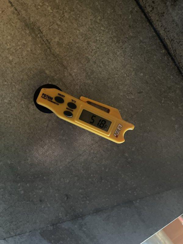 Responded to no cooling complaint on recently installed system. Accessed equipment control interface and verified air conditioner configuration settings including compressor short cycle delay set at 180 seconds, high normal cooling airflow at 1210 CFM, and low normal cooling airflow adjusted to 740 CFM from default. Used digital multimeter to perform electrical diagnostics and confirmed proper system operation.