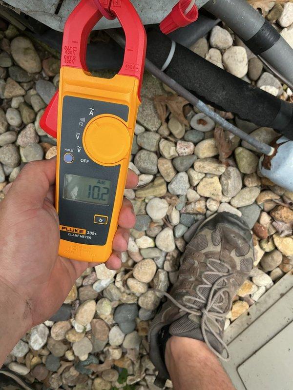 Responded to no cooling call affecting both AC units and thermostats at residential property. Upon arrival, inspected dedicated AC electrical panel and found complete power loss to both systems. Using Fluke 902+ clamp meter, verified incoming voltage at 162V, indicating severe undervoltage condition causing both units and thermostats to shut down. Identified utility power supply issue as root cause requiring electrical service provider intervention. Advised customer to contact utility company immediately to restore proper voltage levels before AC systems can safely resume operation.