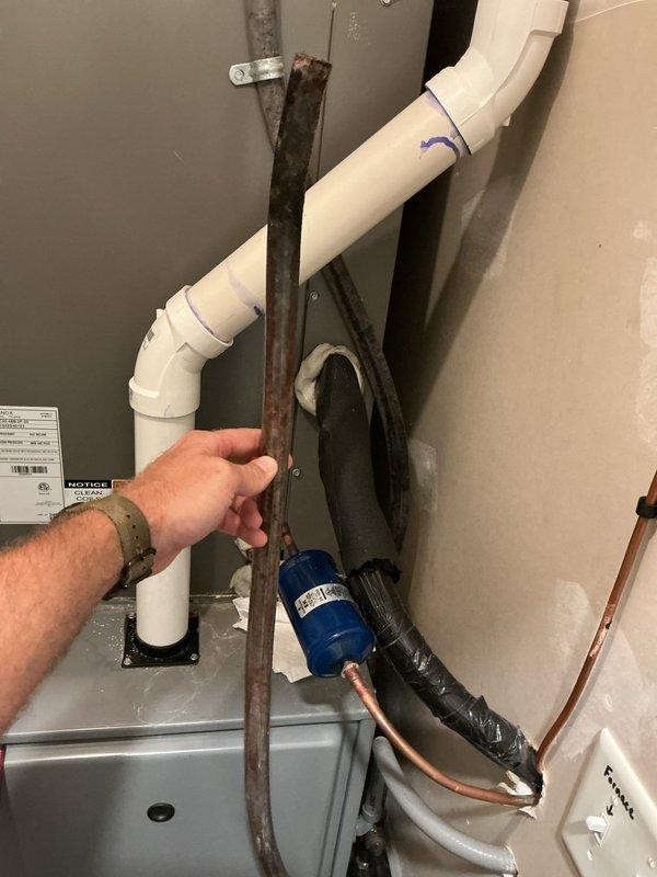 Responded to urgent no-cool call with active water leak on 3-year-old Lennox system. Upon arrival, discovered condensate drain line blockage causing water overflow from unit. Cleared obstruction from drain line and verified proper drainage flow through PVC condensate piping system. Inspected evaporator coil and drain pan for damage; found no cracks or structural issues. Measured temperature differential across coil at 15.3°F, confirming restored cooling operation. Tested system through complete cycle to ensure leak resolved and unit operating within normal parameters. System returned to full cooling capacity with no further water discharge issues.