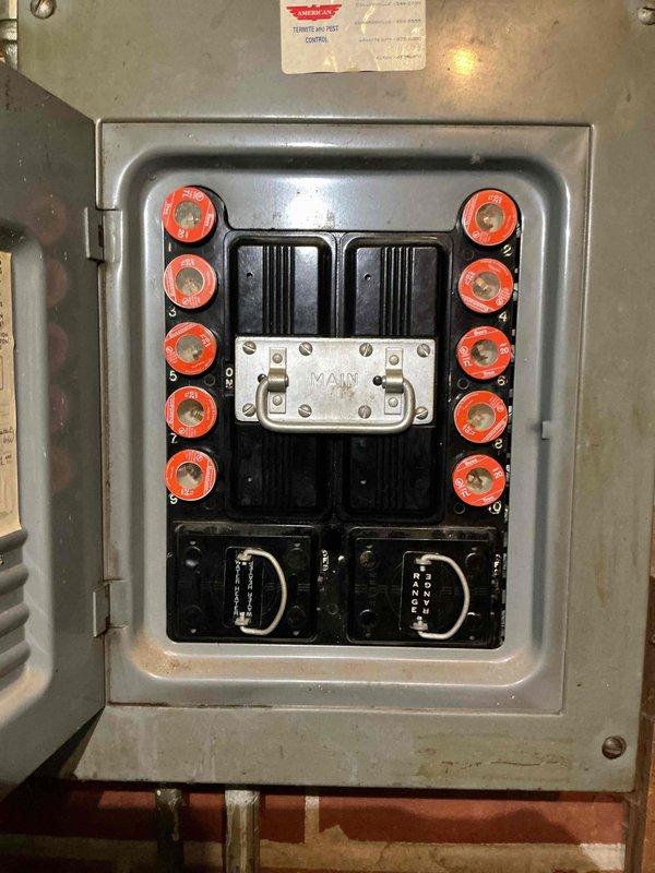 Conducted electrical estimate for upgrading existing 100-amp fuse panel to modern breaker panel. Inspected and photographed current fused electrical service panel with dual vertical rows of cartridge fuses, main disconnect, and aging components mounted in basement utility area. Assessed electrical system configuration, conduit routing, and clearance requirements to provide comprehensive upgrade proposal from obsolete fuse-based system to code-compliant circuit breaker panel.