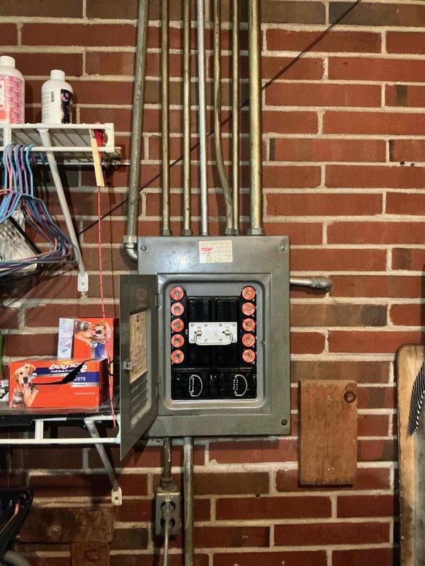 Conducted electrical estimate for upgrading existing 100-amp fuse panel to modern breaker panel. Inspected and photographed current fused electrical service panel with dual vertical rows of cartridge fuses, main disconnect, and aging components mounted in basement utility area. Assessed electrical system configuration, conduit routing, and clearance requirements to provide comprehensive upgrade proposal from obsolete fuse-based system to code-compliant circuit breaker panel.