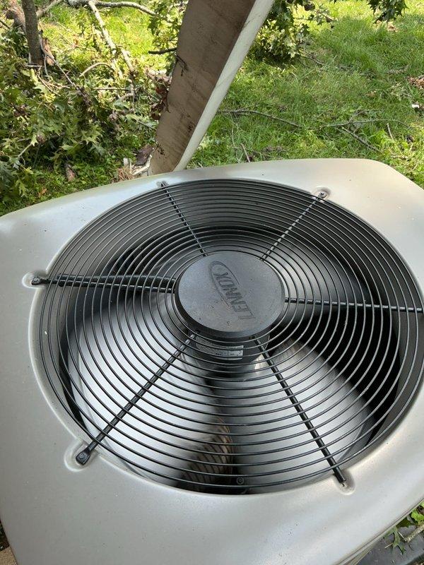 Performed diagnostic inspection on 10-year-old Lennox outdoor condensing unit following reported tree branch impact and power outage. Conducted comprehensive visual examination of cabinet, fan assembly, electrical components, and refrigerant lines. Unit operational with no visible damage to condenser coil, fan motor, compressor, or electrical disconnect; all mechanical and electrical systems functioning within normal parameters.