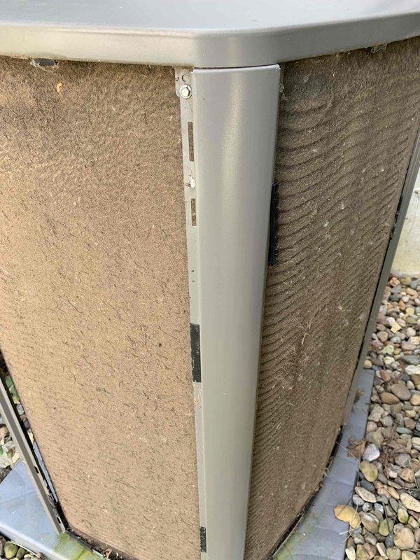 Responded to follow-up call for frozen air conditioning unit. Upon arrival, inspected outdoor condensing unit and found heavily soiled condenser coils with significant dirt and debris accumulation restricting airflow. Documented unit condition with photos showing approximately 10-year-old system installed on side of home with visible buildup on heat exchanger fins. Recommended coil cleaning and further diagnostics to address freezing issue and restore proper system operation.