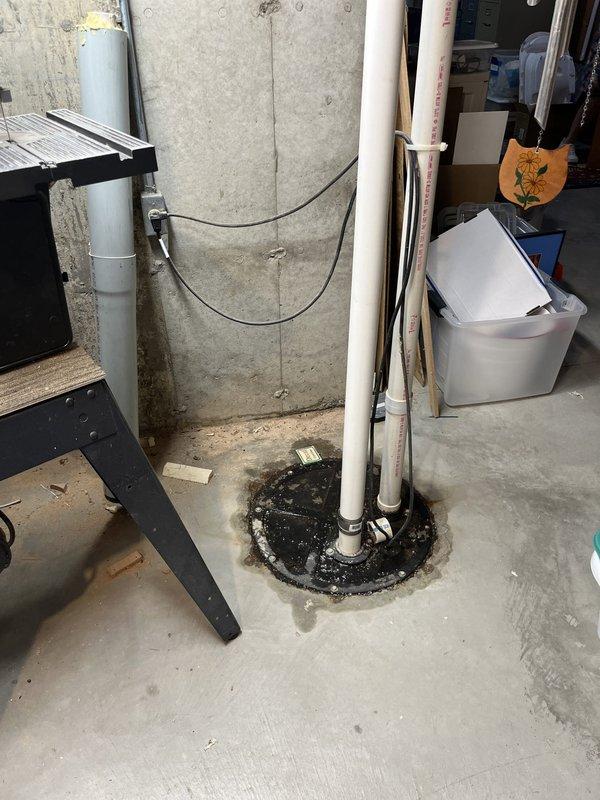 Responded to service call for non-functioning underground sump pump system in basement. Installed grinder pump utilizing existing 2-inch PVC piping infrastructure. Added union fitting on vent side for future serviceability and installed check valve on pump outlet to prevent backflow. Sealed pipe penetrations at floor level with appropriate waterproof sealant material to ensure proper environmental protection and prevent groundwater infiltration.