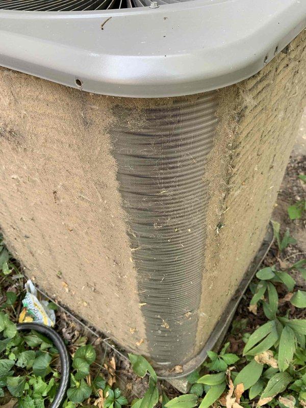 Responded to no cooling complaint on 10+ year old ground-level condensing unit located in backyard. Upon arrival, found exterior unit heavily contaminated with accumulated dirt, dust, and debris on cabinet panels and condenser coil fins, significantly restricting airflow and heat transfer capability. Performed thorough cleaning of condenser coil and exterior surfaces to remove environmental buildup. Inspected indoor furnace unit and associated components including condensate drain system, gas line connections, and ductwork—all found in acceptable operating condition. Unit restored to proper cooling operation following maintenance procedures.