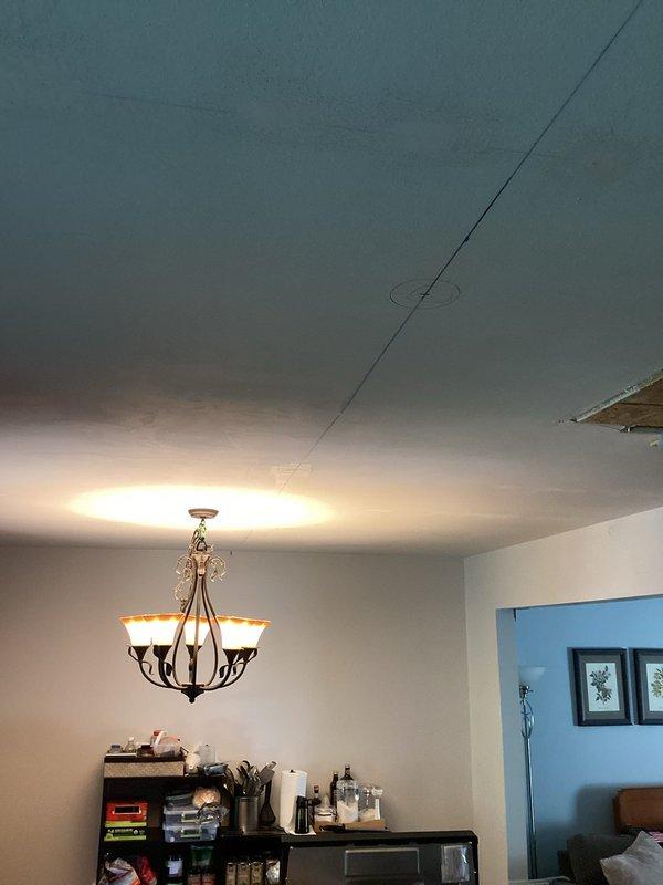 Completed electrical estimate for kitchen and great room area requiring installation of recessed lighting fixtures in ceiling and relocation of existing stove circuit. Assessment revealed ceiling damage present in work area that will need to be addressed prior to final electrical installation. Provided detailed estimate for wiring new recessed can lights throughout ceiling space and relocating 240V range circuit to new position per specifications.