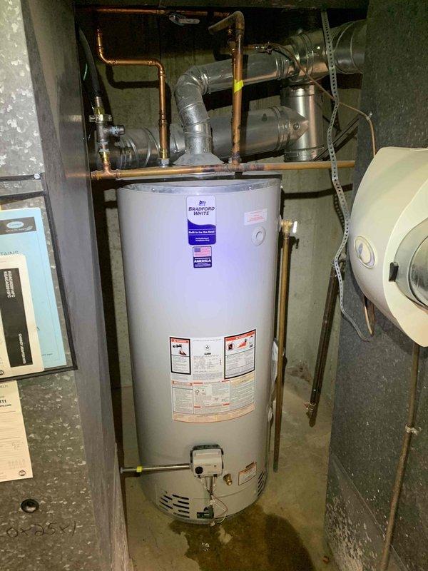 Responded to no cooling complaint on second floor primary bedroom for 9-year-old Carrier system. Performed airflow diagnostics using anemometer at bedroom floor register, measuring 188 CFM and 7-degree temperature differential. Identified restricted airflow issue at affected vent location. Additionally inspected Bradford White water heater per customer concern regarding increased leakage, documented condition with photos showing copper piping connections and tank assembly for further evaluation.