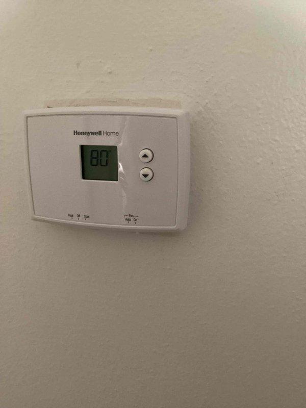 Responded to no-cool call with reported hissing sound on 28-year-old outdoor unit. Upon arrival, customer had already shut off system as previously advised. Performed diagnostic inspection of outdoor unit, checked thermostat operation showing 80°F reading, and examined electrical components including capacitor and contactor assembly. Documented system condition with photos of thermostat and electrical compartment showing aged wiring and weathered components typical of unit's age.