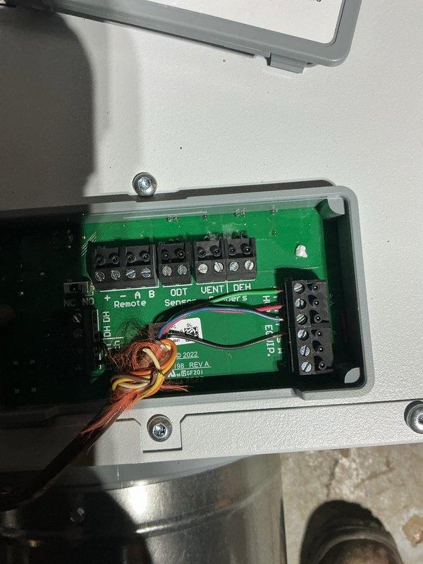 Installed duct-mounted dehumidifier unit to existing HVAC system. Completed electrical wiring connections to control board, terminating wires to appropriate terminal blocks including ODT, VENT, and DEH terminals as specified. System tested and operational for both heating and cooling functions.