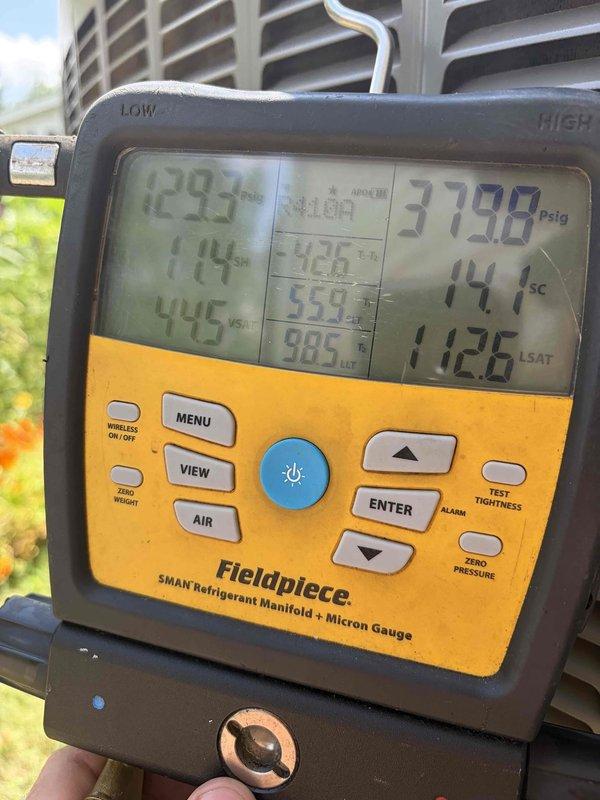 Responded to no cooling complaint on 10+ year old ground-level condensing unit. Upon arrival, performed diagnostic evaluation using refrigerant manifold gauge, which revealed system pressures of 379.8 psig on high side with 11.4°F subcooling and 44.5°F suction temperature. Unit exterior showed significant dirt and debris accumulation from extended service life, indicating need for thorough cleaning to restore proper airflow and heat transfer efficiency.