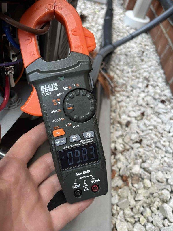 Completed comprehensive cooling season tune-up on 3-year-old outdoor condensing unit. Performed full system inspection including amperage draw verification using clamp meter (reading 9.82A), accessed and inspected condenser coil condition through side panel, and evaluated fan motor operation. All components found operating within normal parameters with no deficiencies noted.